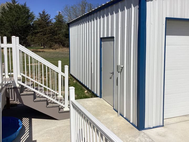 Side View of White and Blue Steel Garage Steel Commander Corp | 40+ Years Expertise | American-Made Steel Buildings